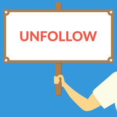 UNFOLLOW. Hand holding wooden sign