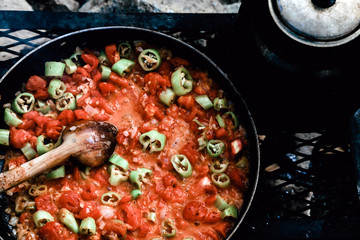 Preparing food on campfire in wild camping