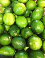 A full frame background of fresh, green limes filling the frame.