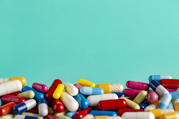 Heap of colorful drugs and pills on color background