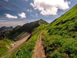 scary hiking path with beautiful scenery view over the swiss alps and mountain lake