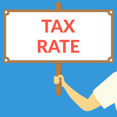 TAX RATE. Hand holding wooden sign