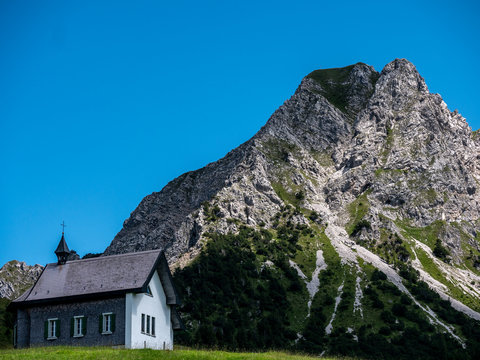 little christian church or chapel isolated in mountain scenery, switzerland alps