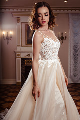 Fototapeta premium Sensual brunette bride in luxury wedding dress over classic interior, fashion beauty portrait