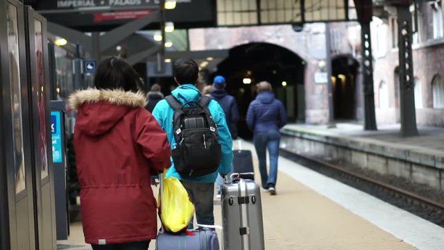 Asian tourists walking at train station in Copenhagen, Europe video