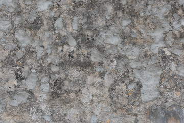 Old rough and damaged grey building facade. Exterior wall surface.