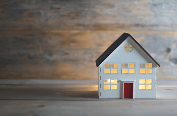 Fototapeta Miniature house over a wooden background obraz
