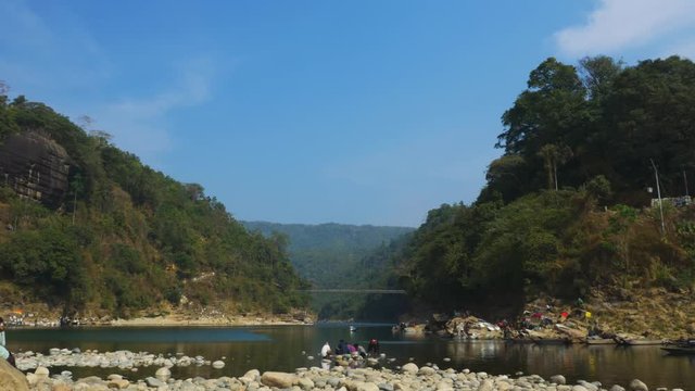 Wide shot showing border between Bangladesh and India from Piyain River