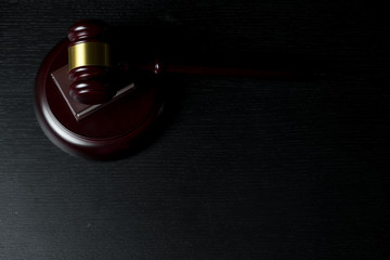 Judge gavel on black wooden background