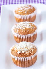 Homemade vanilla muffins with coconut powder. Pink background. Copy space. Selective focus. Blur motion.