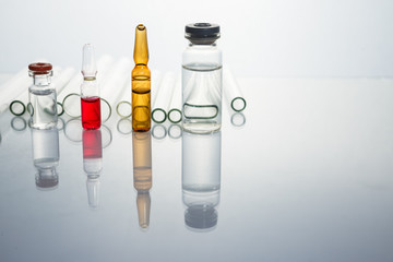 Group of vials with medication on blue methacrylate table. Horizontal composition.