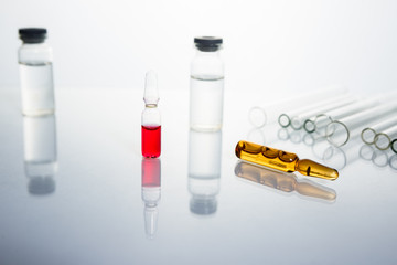 Group of vials with medication on blue methacrylate table. Horizontal composition.
