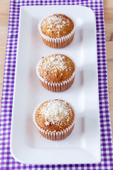 Homemade vanilla muffins with coconut powder. Pink background. Copy space. Selective focus. Blur motion.