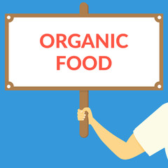 ORGANIC FOOD. Hand holding wooden sign