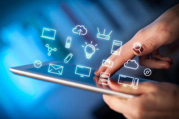 Female hands touching tablet with white technology related icons 