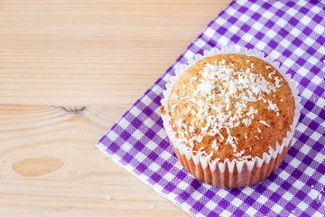 Homemade vanilla muffins with coconut powder. Pink background. Copy space. Selective focus. Blur motion.