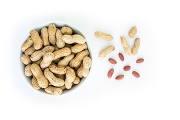 peanut pile in white bowl top view on white background