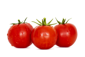 Fresh ripe red tomatoes on the white background. Harvested tomatoes on white background