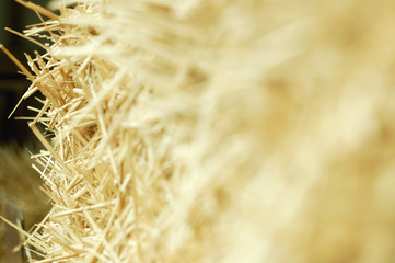 Texture of golden straw. Rustic background. Close-up, selective focus, blurred copy space