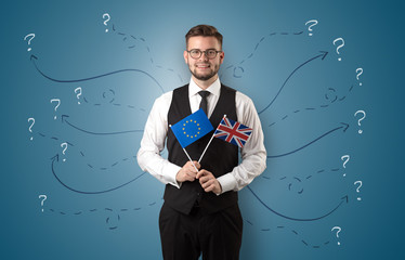 Smiling young man standing with flag and multidirectional arrows around
