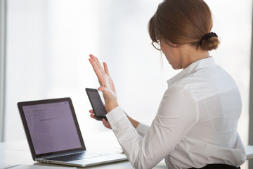 Frustrated female ceo having problems with smartphone, nervous businesswoman experience phone...