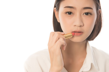 Pretty asian woman short hair applying lipstick, isolated on white, Free from copy space.