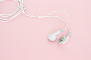earbuds or earphones on pink background