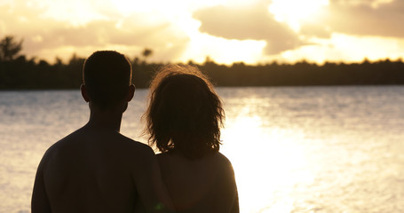  a couple on the beach with sunset