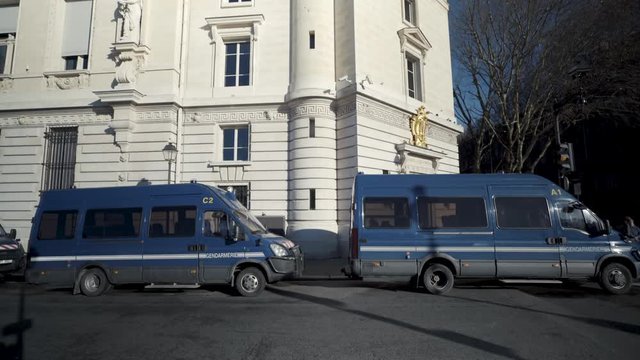 Police vans parked along a Parisian street