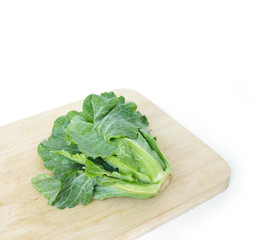 chinese kale on cutting board on white background