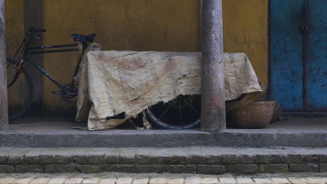 Bike with wagon trailer under covers in a village in Sylhet, Bangladesh