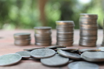 Stack of money coins arranged as a graph on wooden table