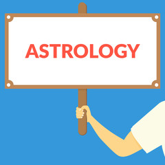 ASTROLOGY. Hand holding wooden sign