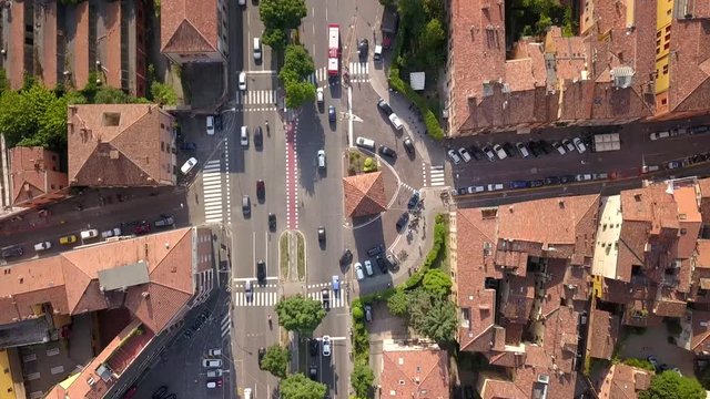 drone shot (down) on the road around Bologna, Italy. its shoots a crossing which has a old city gate.