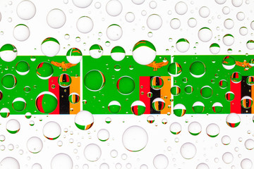 Water drops on glass and flags of Zambia