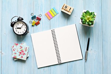 Business, still life, working, holiday or new year planning concept : Desk table with open notebook paper, cube calendar and clock, Top view or flat lay with copy space ready for adding or mock up