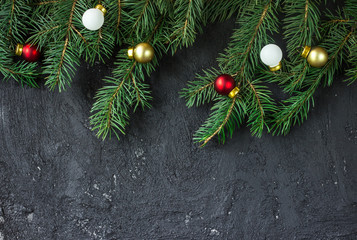 Christmas fir tree on black concrete background with copy space