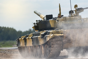 Military or army tank ready to attack and moving over a deserted battle field terrain. a lot of...