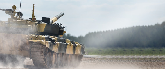 Military or army tank ready to attack and moving over a deserted battle field terrain. a lot of...