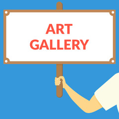 ART GALLERY. Hand holding wooden sign