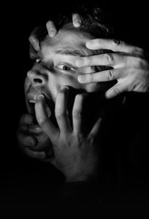 Hands Grabbing a Head in the Dark