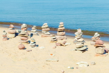 Pyramids of balanced stones in the beach