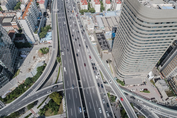 Aerial view of highway and overpass in city on sunny day