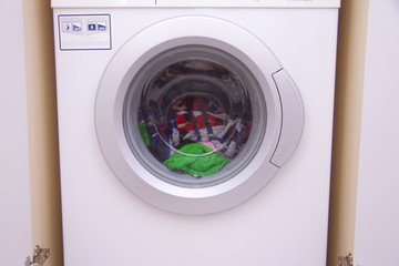 Front view of a washing machine drum during cleaning clothes