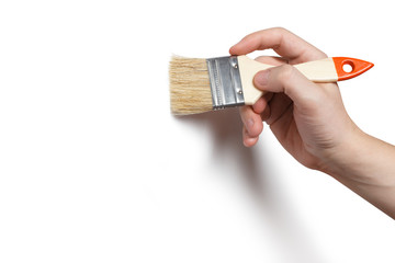 Hand holding a thick brush, isolated on white background