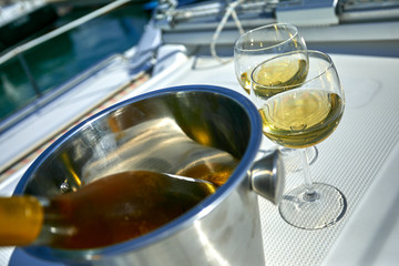 Pair of wineglasses against the yacht