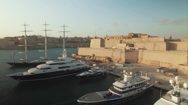 Aerial Shot - Flying over a Fort and luxury Yachts