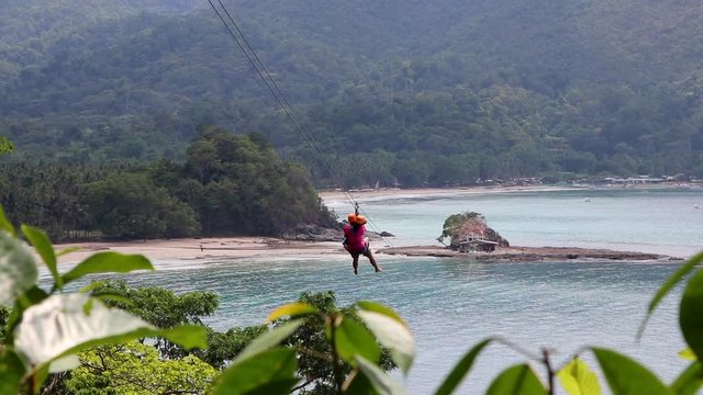 Ziplining Over Tropical Water on a Beach in the Philippines in Slow Motion