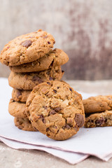 Chocolate oatmeal cookies on the wooden background. - obrazy, fototapety, plakaty