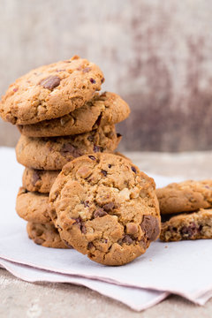 Chocolate oatmeal cookies on the wooden background.